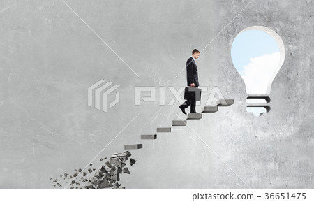 Businessman climbing stone ladder Businessman climbing stone ladder 36651475
