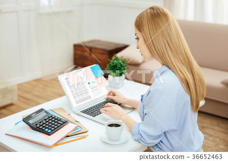 Serious determined woman working on her laptop 36652463