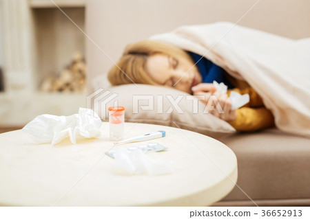 Unwell woman taking a nap to recover soon 36652913