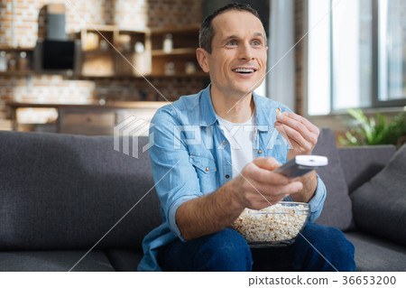 Attractive man looking forward while eating 36653200