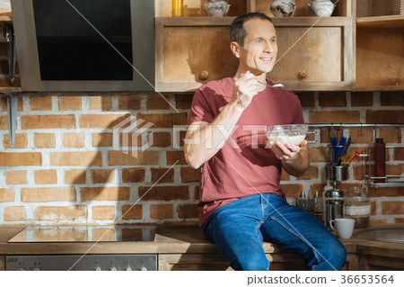 Dreamy man holding glass bowl in left hand 36653564