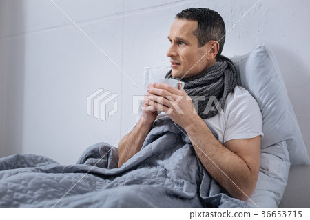 Sick man holding cup with hot tea 36653715