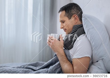 Serious male person going to drink coffee Serious male person going to drink coffee 36653716