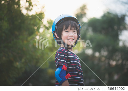Portrait of happy Boy in blue helmet standing 36654902