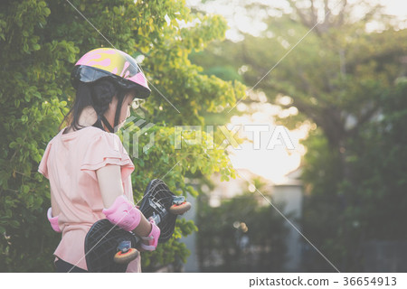 Asian girl with Skateboard and Protective Helmet Asian girl with Skateboard and Protective Helmet 36654913