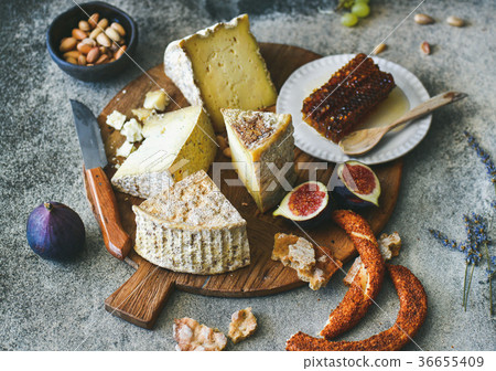 Cheese assortment, figs, honey, freshly baked Cheese assortment, figs, honey, freshly baked 36655409