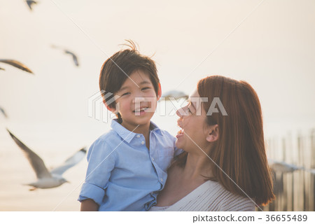 mother and son playing on the beach mother and son playing on the beach 36655489