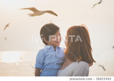 mother and son playing on the beach mother and son playing on the beach 36655493