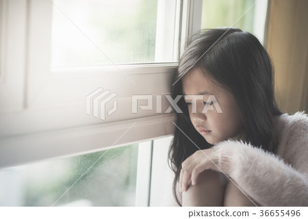 Portrait of asian beautiful sad girl at the window 36655496