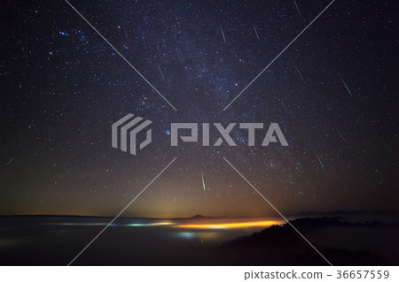 Geminid Meteor in the night sky and fog Geminid Meteor in the night sky and fog 36657559