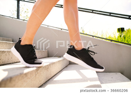 Unrecognizable athlete running down the stairs. Unrecognizable athlete running down the stairs. 36660206