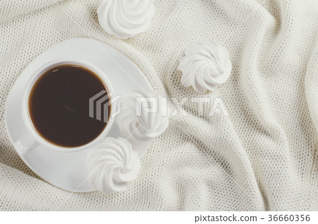 Delicious meringue cookies and cup of hot tea. Delicious meringue cookies and cup of hot tea. 36660356