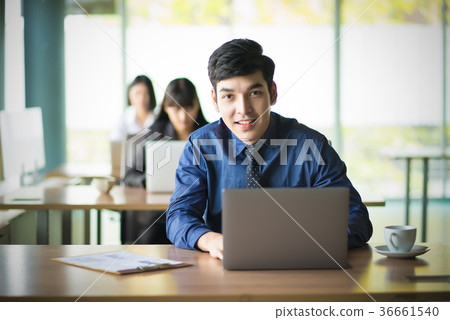 Yong Handsome Business man working at laptop Yong Handsome Business man working at laptop 36661540
