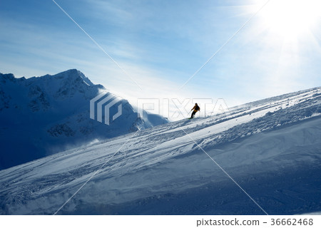 Skier going down the slope 36662468