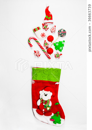 Christmas background with a sock from which Christmas background with a sock from which 36663739