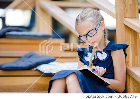 Adorable little school girl with notes and pencils Adorable little school girl with notes and pencils 36663779