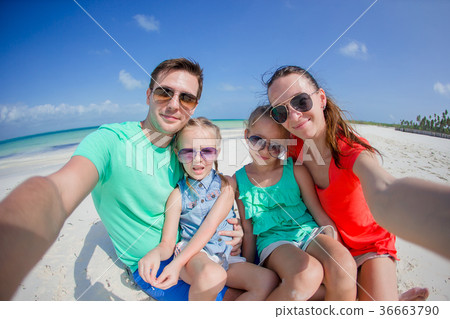 Young beautiful family taking selfie on the beach 36663790
