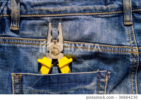 Pliers to repair in pocket of blue jeans Pliers to repair in pocket of blue jeans 36664230