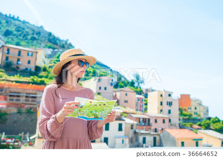 Young woman with map at old village Riomaggiore Young woman with map at old village Riomaggiore 36664652