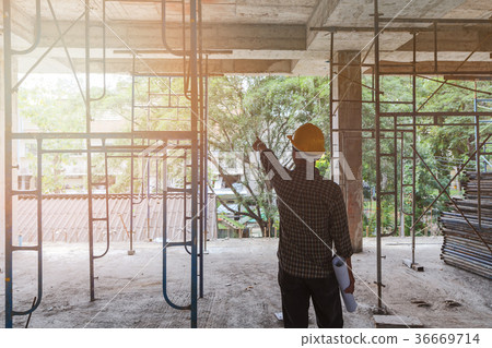 Engineer with blueprint in construction site Engineer with blueprint in construction site 36669714