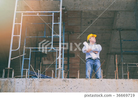 Engineer with blueprint in construction site 36669719