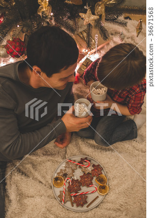 Father and son laying under christmas tree. Father and son laying under christmas tree. 36671568