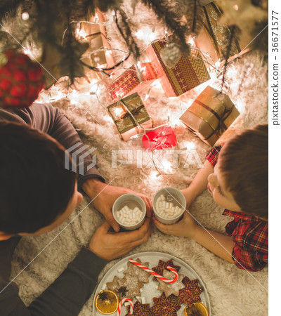Father and son laying under christmas tree. Father and son laying under christmas tree. 36671577