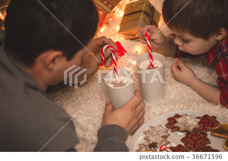 Father and son laying under christmas tree. 36671596