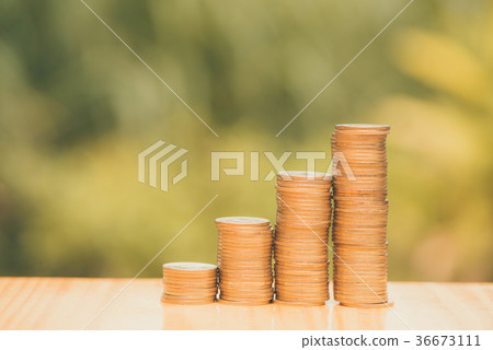 Growing coins stacks with bokeh background Growing coins stacks with bokeh background 36673111