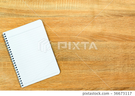 Notebook on wood table top view with copy space. Notebook on wood table top view with copy space. 36673117