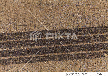 Tire tracks on road 36675685