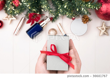 Cosmetic products in gift box on wooden background 36681767