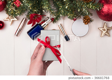 Cosmetic products in gift box on wooden background 36681768