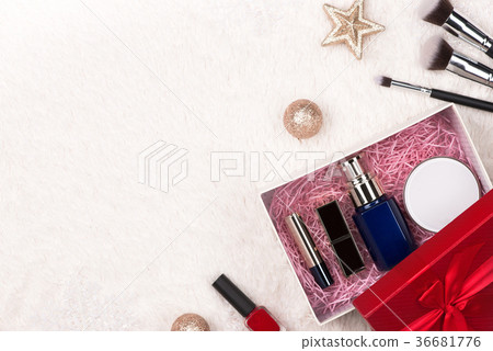 Flat lay of christmas ball, gift and cosmetic Flat lay of christmas ball, gift and cosmetic 36681776