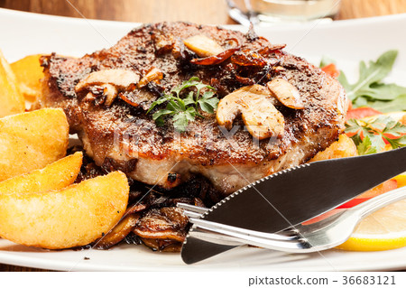 Pork chop with mushrooms and chips Pork chop with mushrooms and chips 36683121