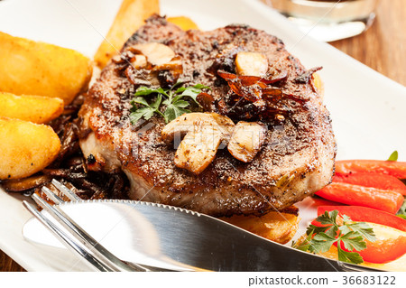 Pork chop with mushrooms and chips Pork chop with mushrooms and chips 36683122