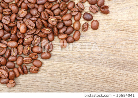 Coffee grains on grunge wooden background. Coffee grains on grunge wooden background. 36684041