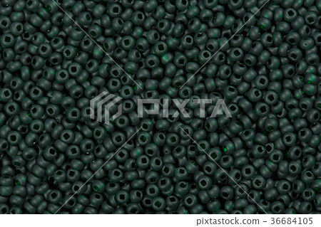 Dark green seed beads background. Dark green seed beads background. 36684105