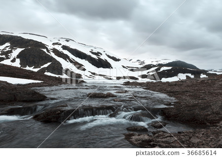Typical norwegian landscape with snowy mountains Typical norwegian landscape with snowy mountains 36685614