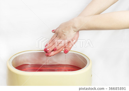 Process paraffin treatment of female hands in beau Process paraffin treatment of female hands in beau 36685891