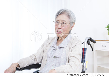 Senior women riding a wheelchair Senior women riding a wheelchair 36685979