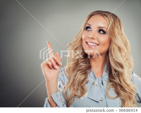 Perfect Young Woman Pointing her Finger Up 36686914