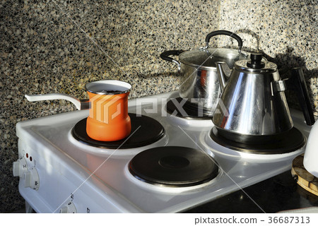 pot, kettle and coffee pot on the stove pot, kettle and coffee pot on the stove 36687313