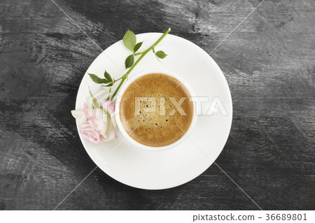 Espresso coffee in a white cup and a pink rose Espresso coffee in a white cup and a pink rose 36689801