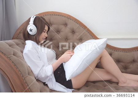 Beautiful woman listen music from headphone 36693114