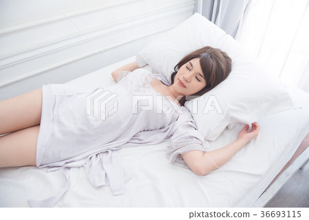Beautiful girl sleeping on bed 36693115