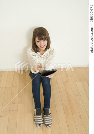 A woman watching a tablet A woman watching a tablet 36695473
