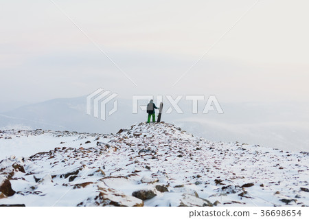 man snowboarder stands with snowboard on mountain man snowboarder stands with snowboard on mountain 36698654