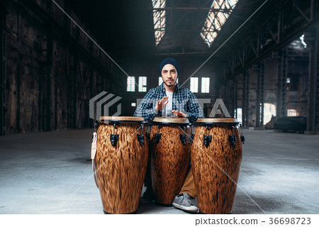 Male drummer plays on wooden drum 36698723