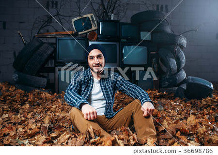 Stalker, mountain of old TVs on background Stalker, mountain of old TVs on background 36698786